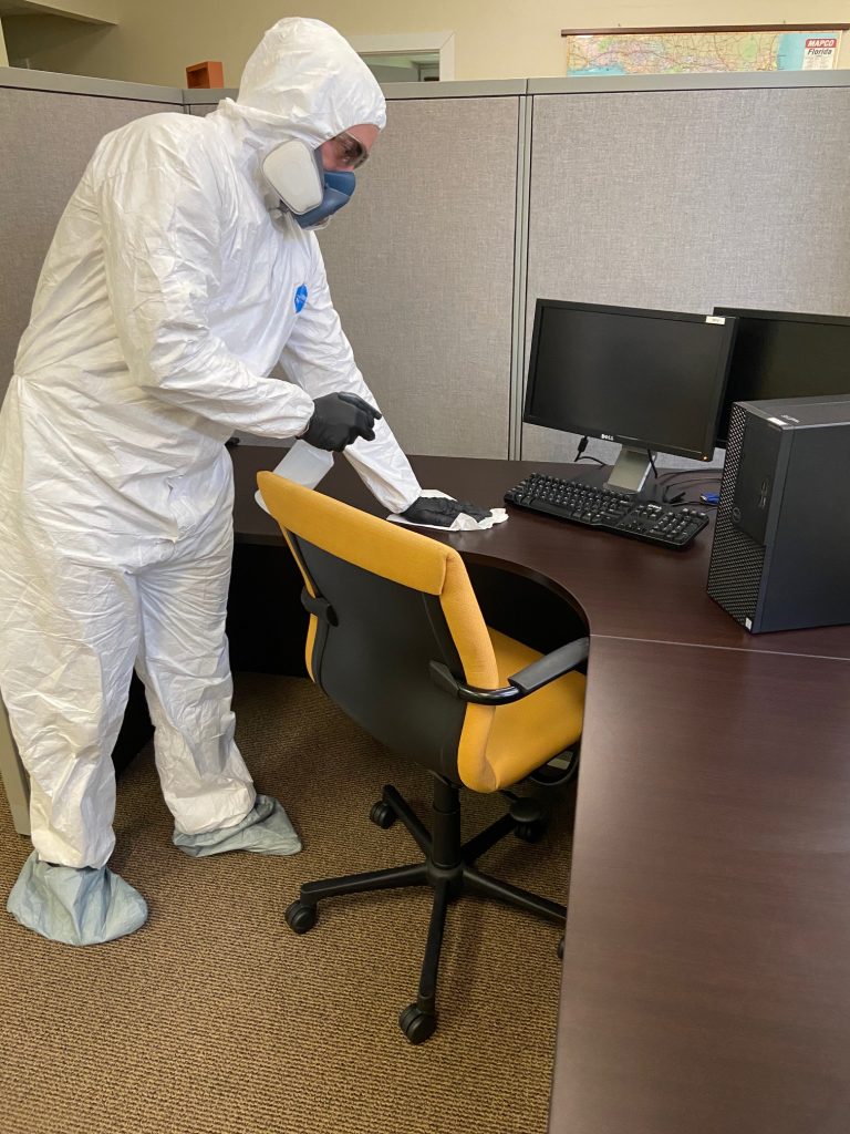 Technician applying disinfecting treatment
